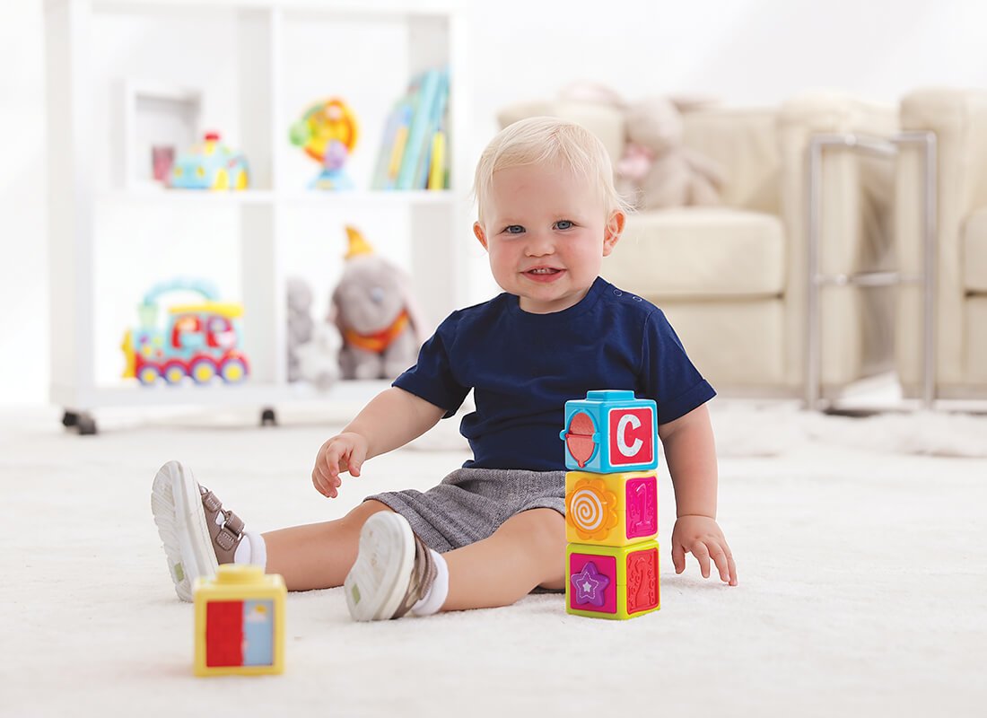 baby boy playing with Stacking Blocks
