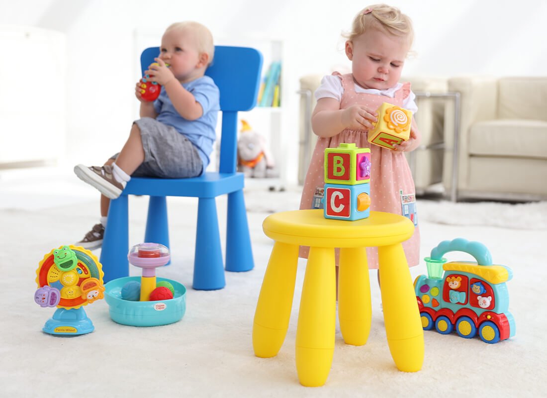 babies playing with hapee capee toys